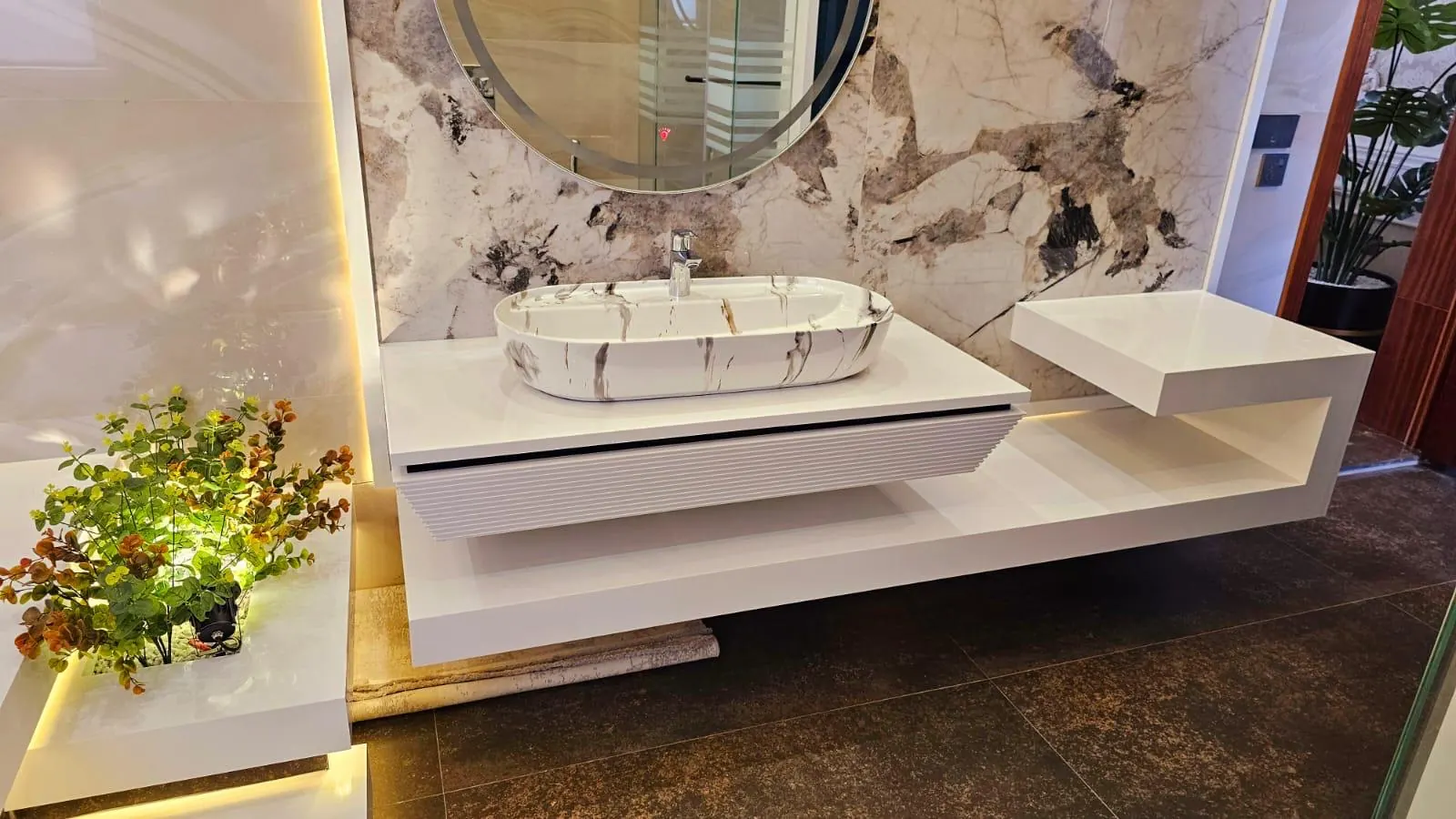 Floating Corian bathroom vanity with an integrated seamless basin in a Lahore home.